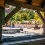 hot tub with paver patio and retaining wall