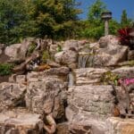 water feature with led lighting, mountain boulders, and waterfall