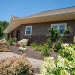 landscaping with natural stone stairs and paver sidewalk