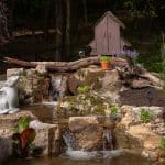 mountain boulders with backyard pond and landscaping
