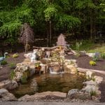 mountain boulders with backyard pond and landscaping