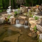 pond with mountain boulders and landscaping