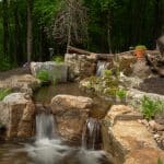 waterfall on backyard pond and mountain boulders