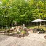 flagstone patio with landscaping and pond