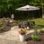 flagstone patio with landscaping and pond