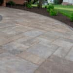 outdoor lighting in mulch bed with plantings with paver side walk