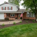 outdoor lighting in mulch bed with plantings with paver side walk