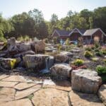 flagstone patio with outdoor living space featuring a fire pit and water feature with water falls