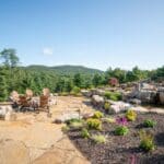 flagstone patio with outdoor living space featuring a fire pit and water feature with water falls