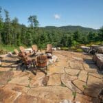 flagstone patio with outdoor living space featuring a fire pit and water feature with water falls
