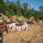 flagstone patio with outdoor living space featuring a fire pit and water feature with water falls