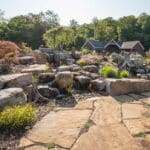 flagstone patio with outdoor living space featuring a fire pit and water feature with water falls