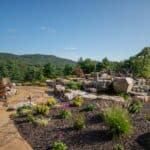 flagstone patio with outdoor living space featuring a fire pit and water feature with water falls