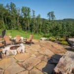 flagstone patio with outdoor living space featuring a fire pit and water feature with water falls