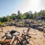 flagstone patio with outdoor living space featuring a fire pit and water feature with water falls
