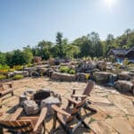 flagstone patio with outdoor living space featuring a fire pit and water feature with water falls