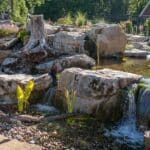 boulders with a water feature and pond