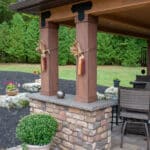 Outdoor living space with patio, pavilion, pond, and landscaping