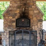 outdoor fire place on a patio with pavilion