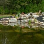 pond with waterfall and landscaping