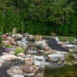 pond with waterfall and landscaping