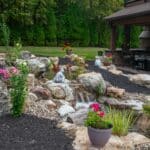 pond with waterfall and landscaping