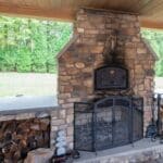 outdoor fire place on a patio with pavilion