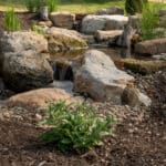 water feature with pond and mountain stream with boulders