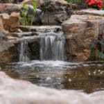 waterfall with koi pond, mountain boulders, and landscaping