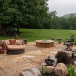 waterfall with koi pond, mountain , boulders, fire pit, flagstone patio and landscaping