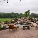waterfall with koi pond, mountain , boulders, flagstone patio and landscaping
