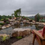 waterfall with koi pond, mountain boulders, and landscaping