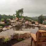 waterfall with koi pond, mountain boulders, and landscaping