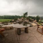 waterfall with koi pond, mountain , boulders, flagstone patio and landscaping