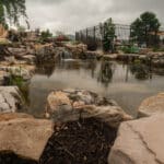 waterfall with koi pond, mountain boulders, and landscaping