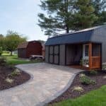 wide paver side walk with landscaping and outdoor lighting