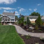 outdoor living space with paver patio, firepit, natural stepping stones, mulch planting beds, and landscaping