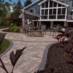 outdoor living space with paver patio, firepit, natural stepping stones, mulch planting beds, and landscaping