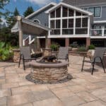 outdoor living space with paver patio, firepit, natural stepping stones, mulch planting beds, and landscaping
