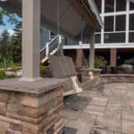outdoor living space with paver patio, firepit, natural stepping stones, mulch planting beds, and landscaping