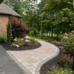 paver walk way with mulch planting beds and sidewalk