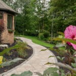 paver walk way with mulch planting beds and sidewalk