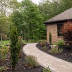paver walk way with mulch planting beds and sidewalk