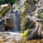 waterfall with mountain boulders