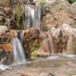 waterfall with mountain boulders