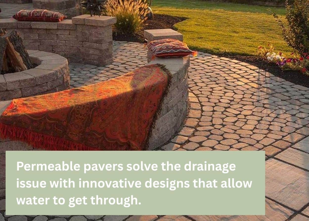A backyard patio built with permeable pavers, showing a circular stone fire pit surrounded by curved seating and colorful throw blankets, designed for natural water drainage. Caption: Permeable pavers solve the drainage issue with innovative designs that allow water to get through.