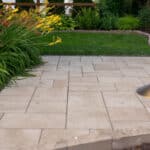 paver sidewalk with pergola and landscaping and edging