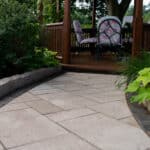 paver sidewalk with pergola and landscaping and edging