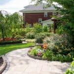 paver sidewalk with pergola and landscaping and edging