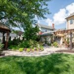 paver sidewalk with pergola and landscaping and edging